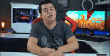 a man is sitting in front of a computer screen that says prototype