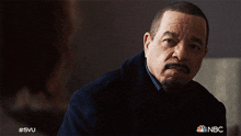 a man with a beard is looking at the camera with a nbc logo in the corner