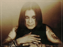 a man with long hair and a tattoo on his arm