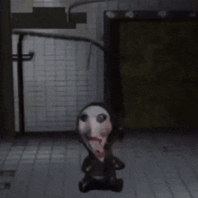 a stuffed animal with a scary face is standing in a room