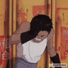 a man in a white tank top is standing in front of a wall with chinese characters on it