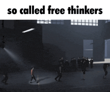 a group of people are standing in a dark room with the words so called free thinkers above them