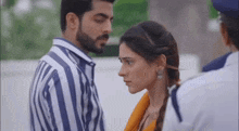 a man and a woman are standing next to each other .