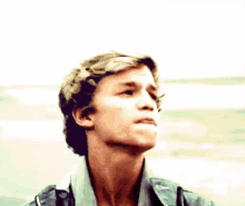 a close up of a young man 's face with his mouth open .