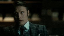 a close up of a man in a suit and tie