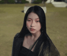 a close up of a woman 's face with long black hair