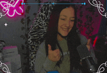 a girl giving a thumbs up in front of a microphone that says tp link