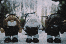 three stuffed cats are standing next to each other with the word attrak on the bottom left corner