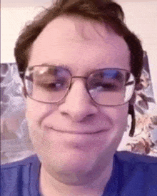 a close up of a man wearing glasses and a headset making a funny face .
