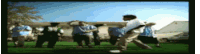 a group of people are dancing in a field in front of a house