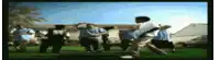 a group of people are dancing in a field in front of a house