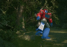 a red and blue robot with a transformer logo on it