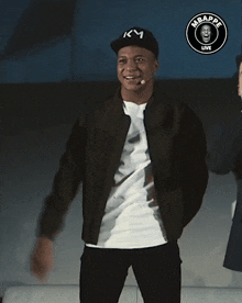 a man wearing a black hat with km on it