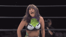 a woman with purple hair and a green and purple top