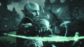 a man in armor is holding a green glowing object