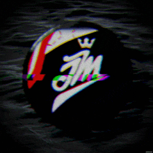 a black ball with the letters jm and a crown