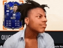a man is making a funny face in front of a card for messi .