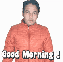 a man wearing an orange jacket with the words good morning written on it