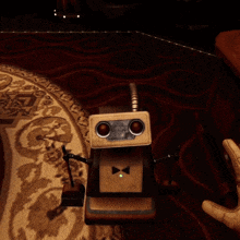 a person 's hand is pressing a button on a machine with a green light on it