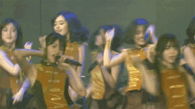 a group of young women are singing into microphones and dancing
