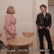 a man and a woman are standing next to each other and the woman is saying oh my god you 're so different !!!