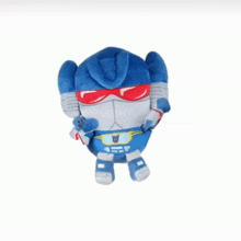 a stuffed toy that looks like a robot with a transformer logo on his chest