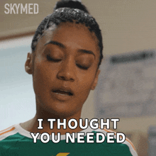 a woman says " i thought you needed " while wearing a green and white shirt