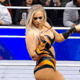 a woman in a wrestling ring holding a pair of glasses