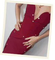 a woman wearing a red dress with pearls and rings