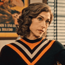 a woman wearing a striped sweater is looking at something