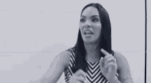 a woman in a black and white striped dress is talking to someone .
