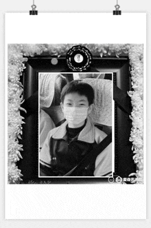 a black and white photo of a boy in a mask
