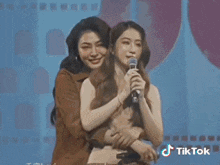 two women wearing sunglasses are posing for a picture with a tiktok logo on the bottom