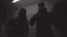 a black and white photo of a person holding a light