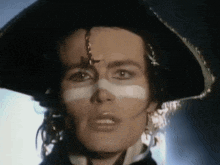 a close up of a woman wearing a pirate hat