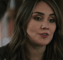 a close up of a woman 's face with brown hair