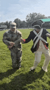 a man in a military uniform holds the hand of another man in a military uniform