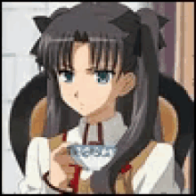a girl is sitting in a chair drinking from a cup .