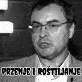 a black and white photo of a man with the words przenje i rostiljanje written below him