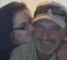 a woman is kissing a man on the cheek