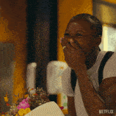 a woman is laughing while holding a bouquet of flowers with netflix written on the bottom