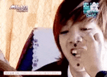 a close up of a person making a funny face with their hand .