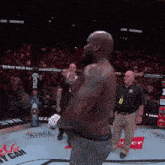 a man stands in a boxing ring with a sign that says serve your way
