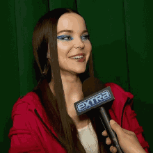 a woman is being interviewed by someone with an extra microphone