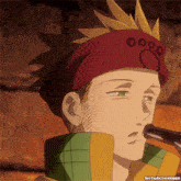 a close up of a person wearing a red headband with a paw print on it