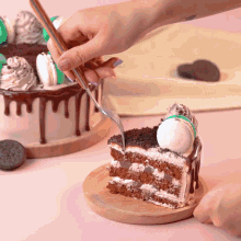 a person is holding a fork over a piece of cake