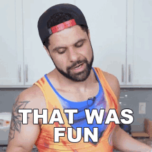 a man with a beard wearing a hat and a tank top says that was fun