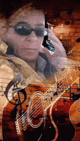 a man wearing sunglasses is talking on a cell phone while playing a guitar .