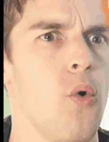 a man is making a funny face with his mouth open .