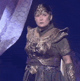 a woman in armor is standing in front of a dragon statue
